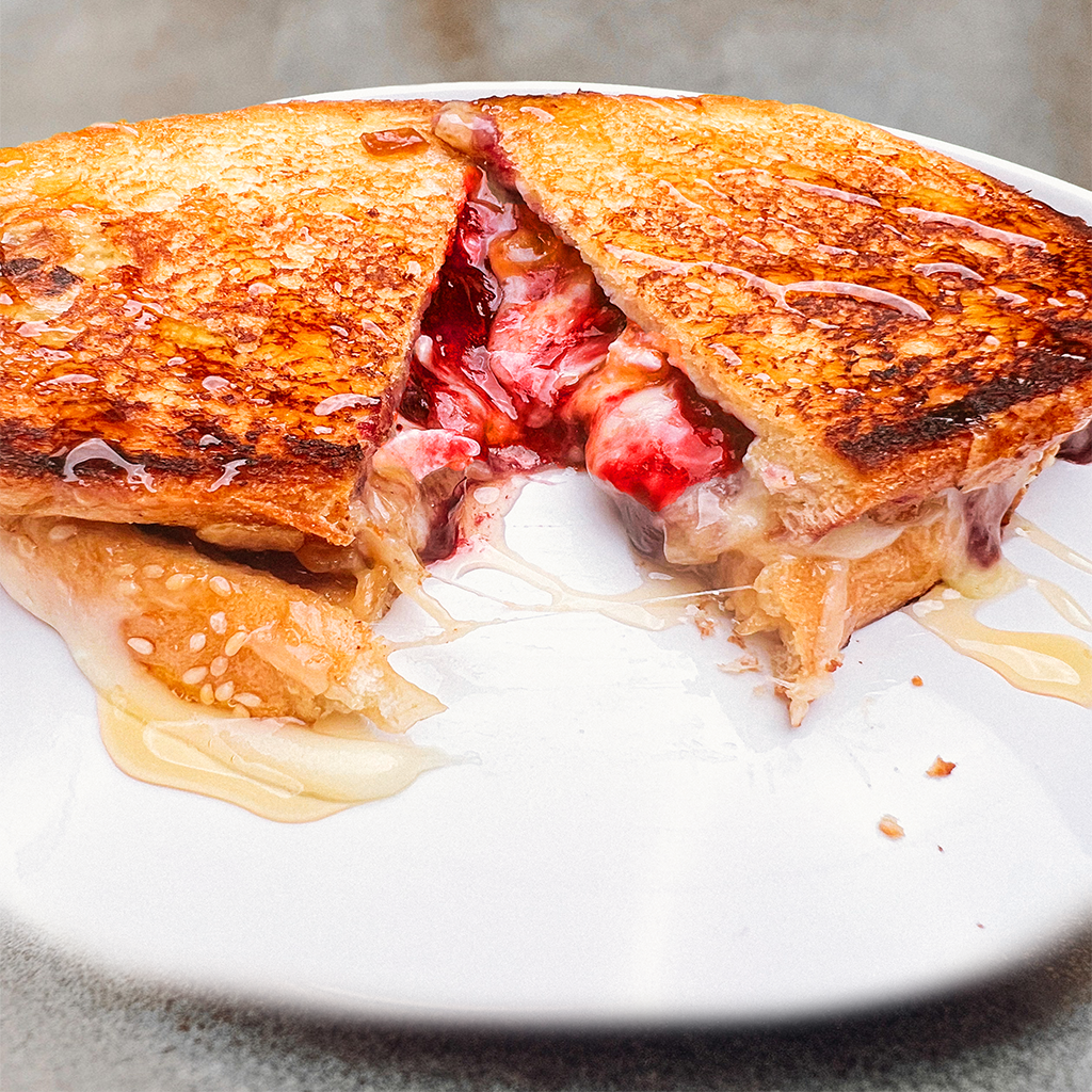 breakfast sweet sour grilled cheese with bacon onion jam brie berry jam.webp
